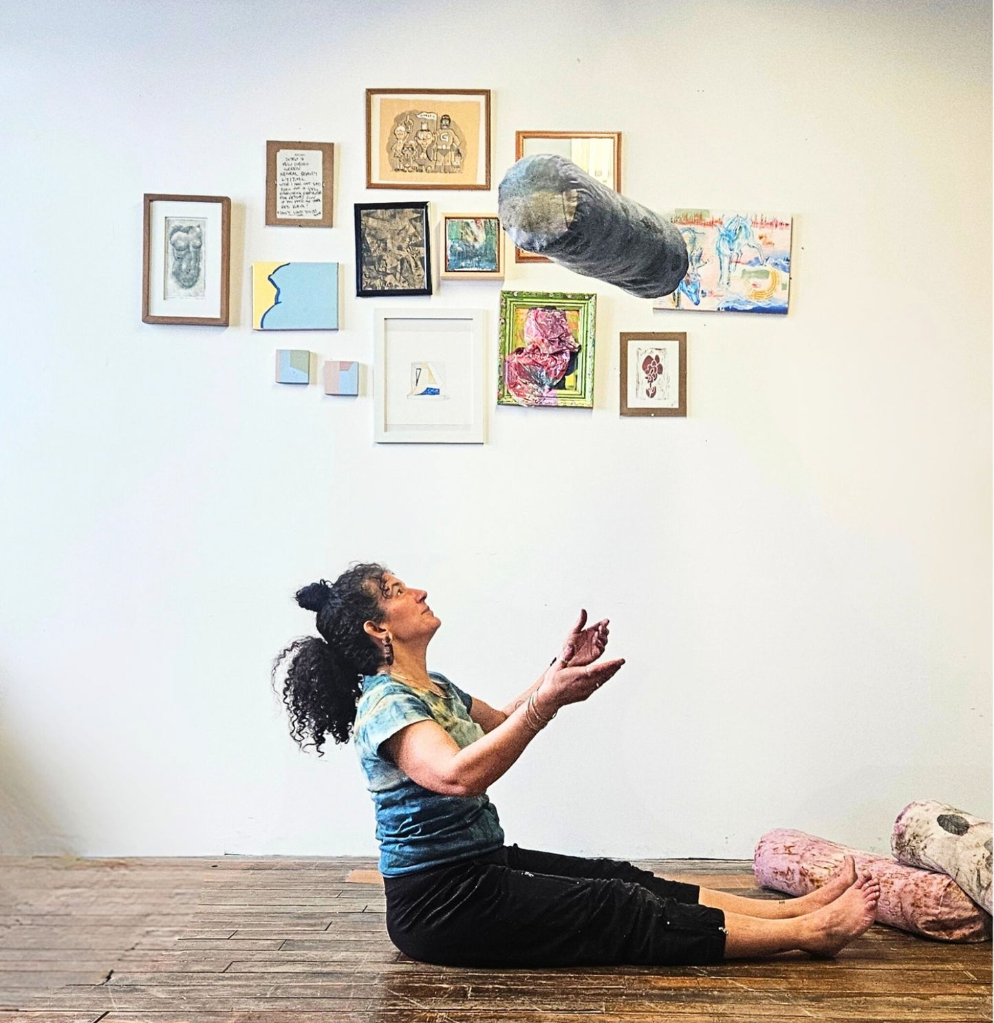Woman practicing yoga in a room with artistic wall decorations