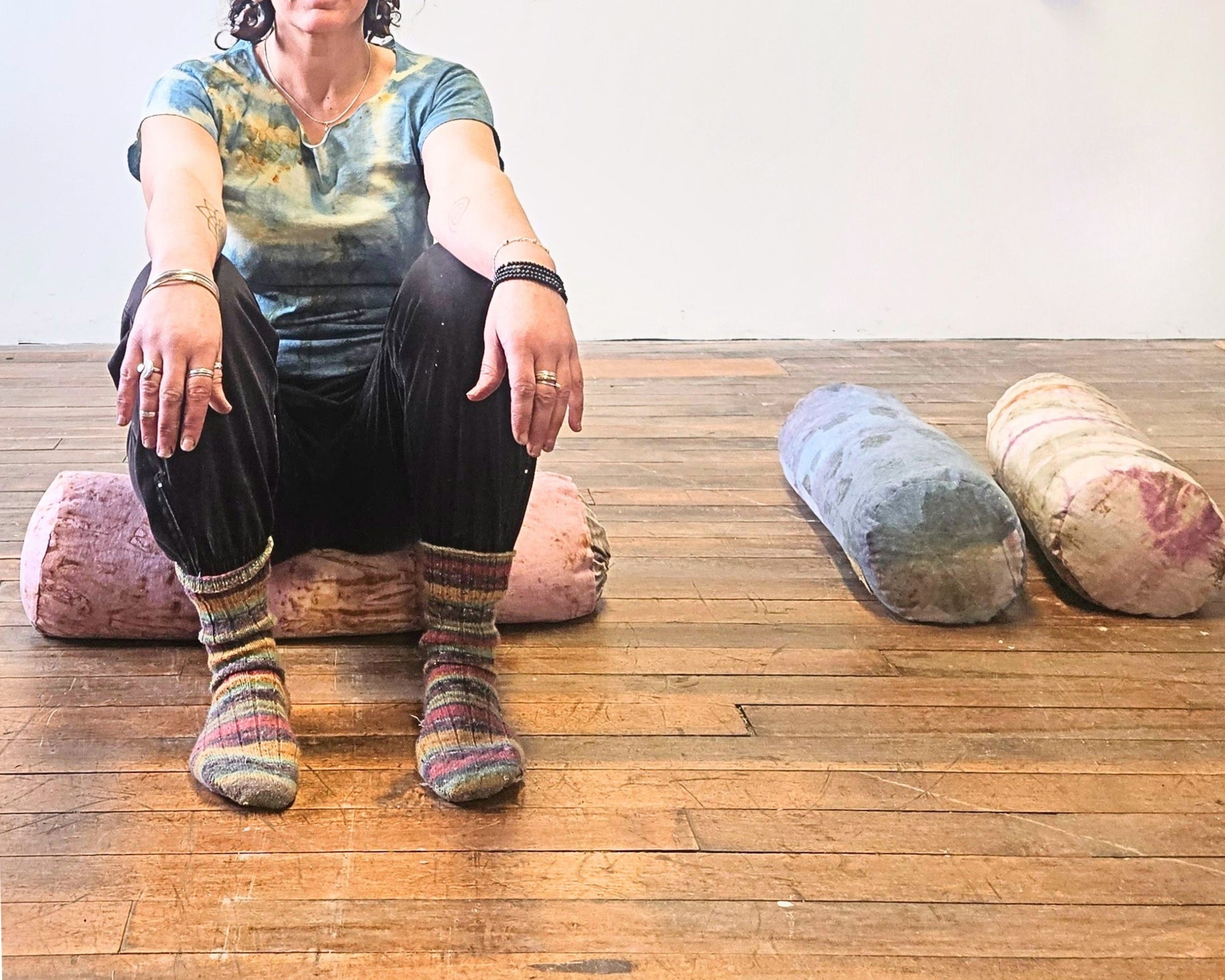 person sitting on a yoga bolster