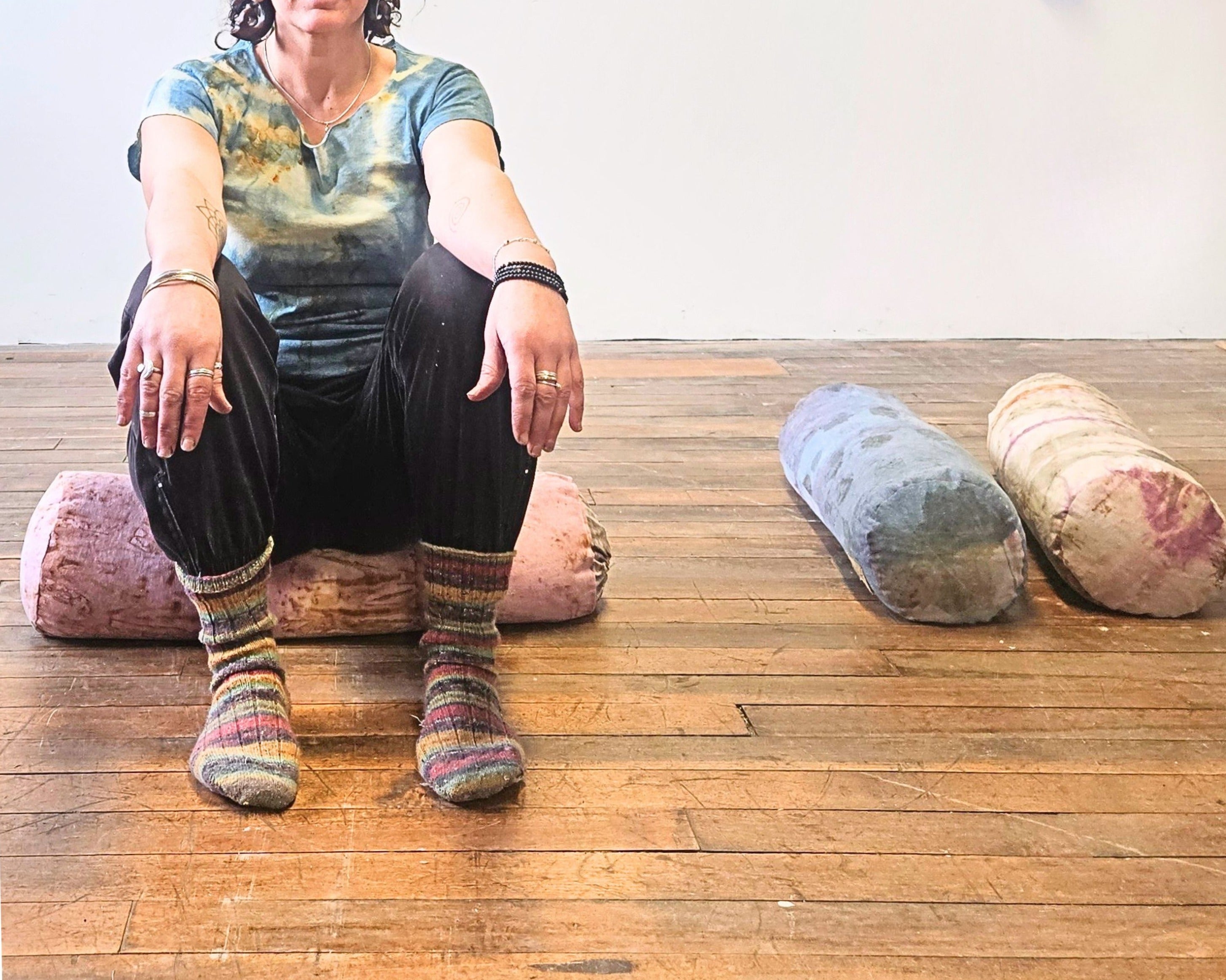 person sitting on a yoga bolster