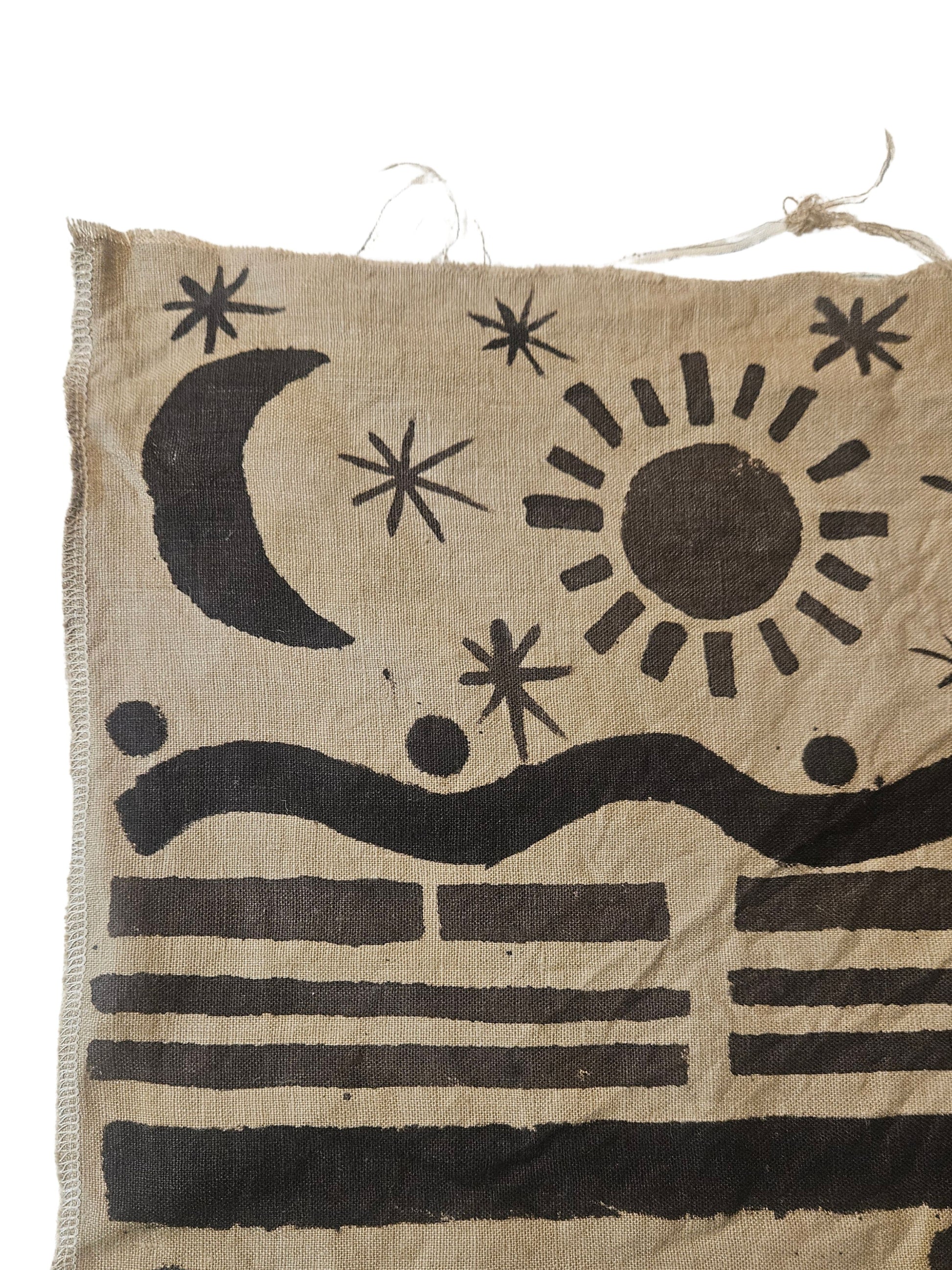 Textile with black abstract designs on a beige background